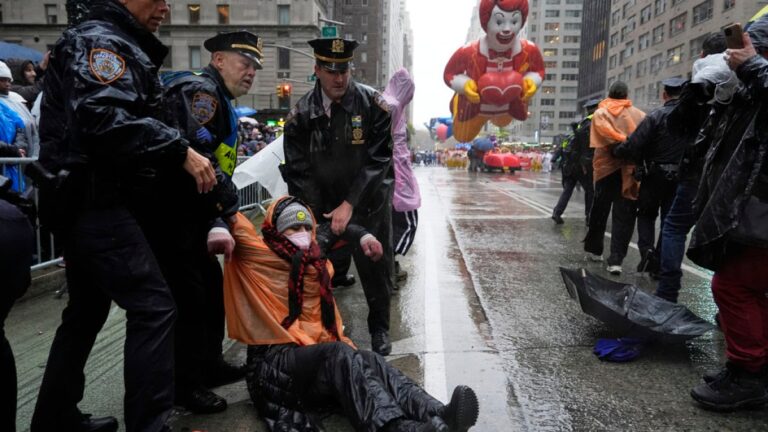 Dozens of protesters arrested at Macy's Thanksgiving Day Parade as rain drenches crowd